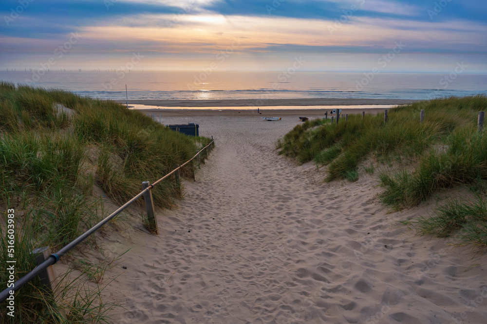 Beach access to the Dutch North Sea at Egmond aan Zee in the evening at sunset