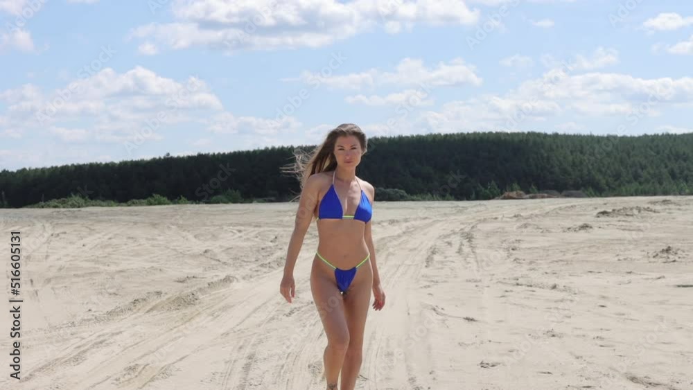 Sensual woman in bikini walking on beach Sensual woman in bikini walking on beach
