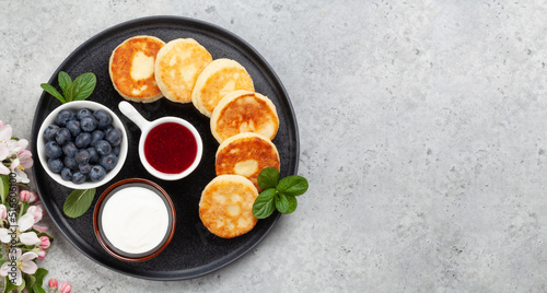 Cottage pancakes with jam, sour cream and berries