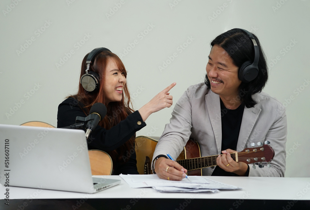 duo artists chatting joyfully while live streaming music radio with fan club on laptop social media...... duo artists chatting joyfully while live streaming music radio with fan club on laptop social media......