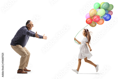 Full length profile shot of a mature man waiting to hug a girl with balloons