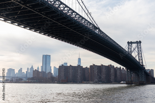 Williamsburg Bridge along the East River with a Manhattan Skyline View in New York City on a Cloudy Day