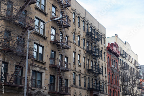 Row of Old Brick Residential Buildings with Fire Escapes in Williamsburg Brooklyn of New York City © James