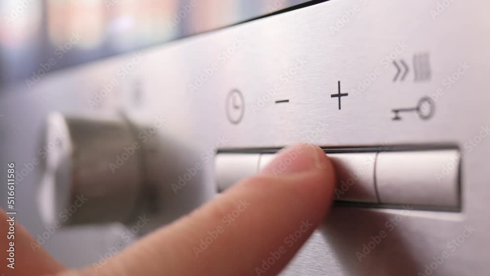 Turning on the mode switch and setting the time on electric oven. Male