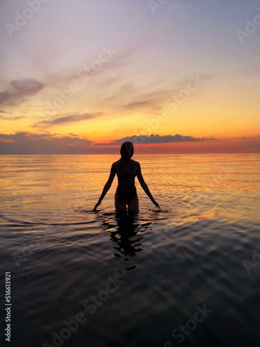 women on orange sunset at sea nature background  © Aleksandr
