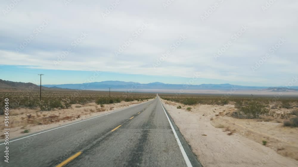Driving On Asphalt Highway Road Passing Through Arid Desert Valley Of Death Driving On Asphalt Highway Road Passing Through Arid Desert Valley Of Death