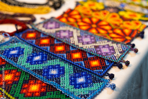 Colorful huichol bracelets at night market in Guadalajara, Mexico. Traditional Mexican handcraft souvenirs