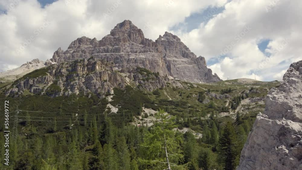 Tre Cime di Lavaredo seen from the face with Rifugio Auronzo, panning 4k footage Tre Cime di Lavaredo seen from the face with Rifugio Auronzo, panning 4k footage