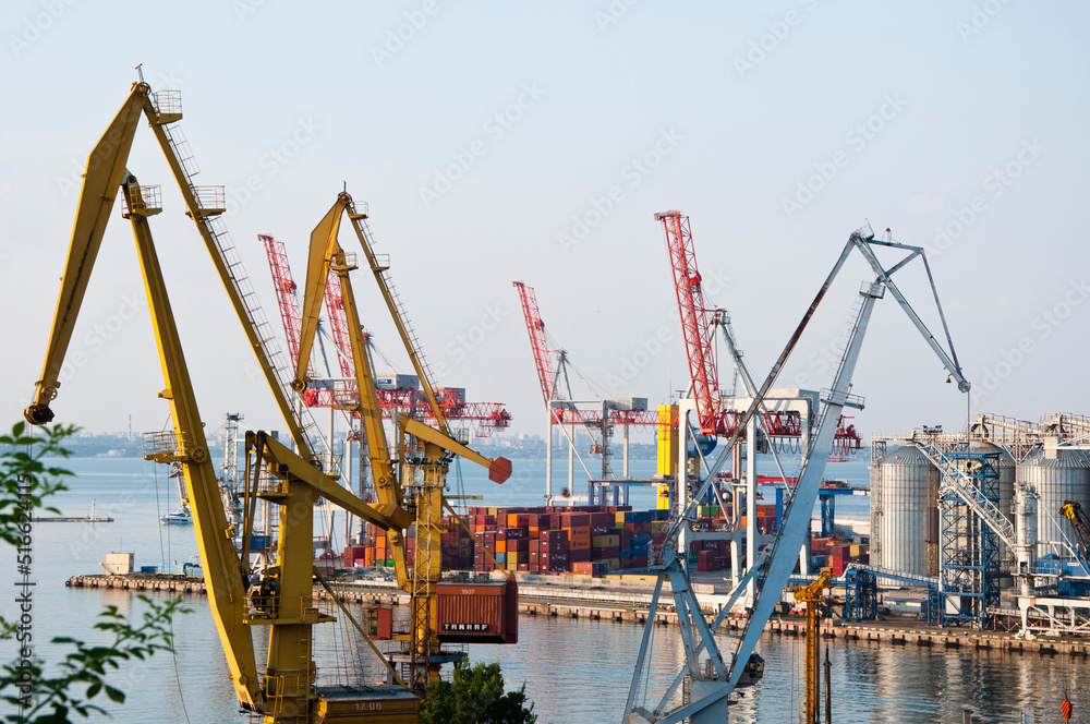 Marine container cranes in seaport of Odesa sky background