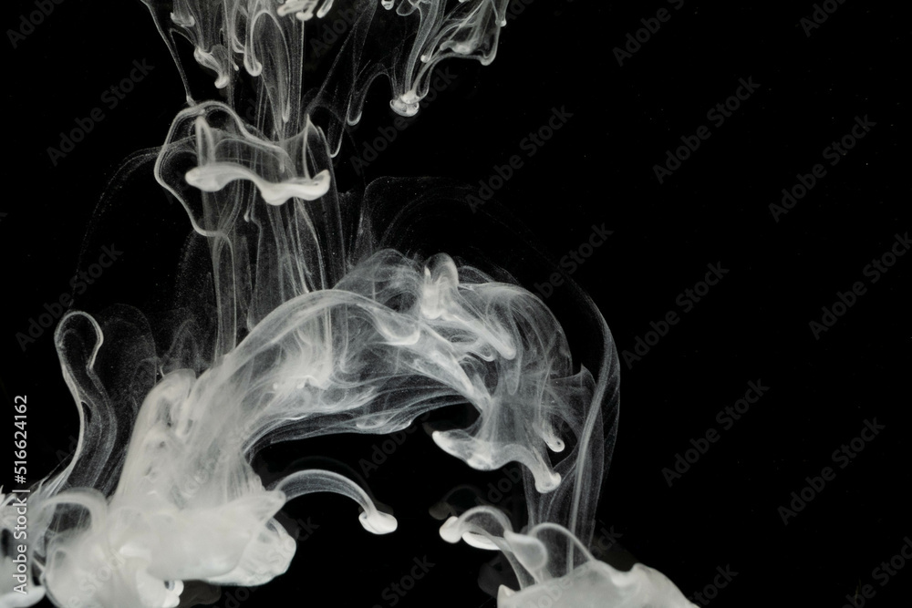 Fototapeta premium selective focus white liquid drop in clear water with lighting, look like smoke in the night.