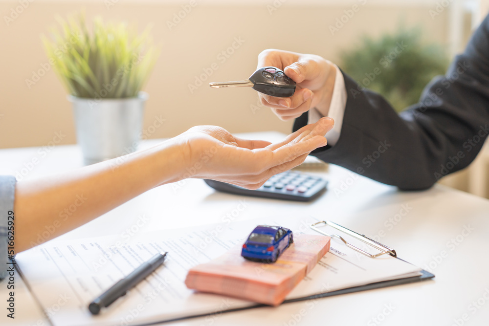 Business car rental company service, Close up hand of agent dealer giving, holding car key to customer renter, new owner after signed rental, purchase contract in document, vehicle sales agreement. - obrazy, fototapety, plakaty 