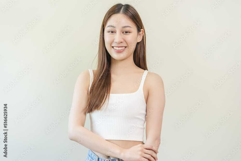 Smiling positive, attractive asian young woman wearing casual dress, portrait of beautiful brunette her with long brown hair, feeling happy looking to camera standing isolated on white background. Smiling positive, attractive asian young woman wearing casual dress, portrait of beautiful brunette her with long brown hair, feeling happy looking to camera standing isolated on white background.
