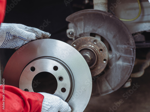 Process of replacing brake discs with Brand new. Auto mechanic repairing in garage Car brakes
