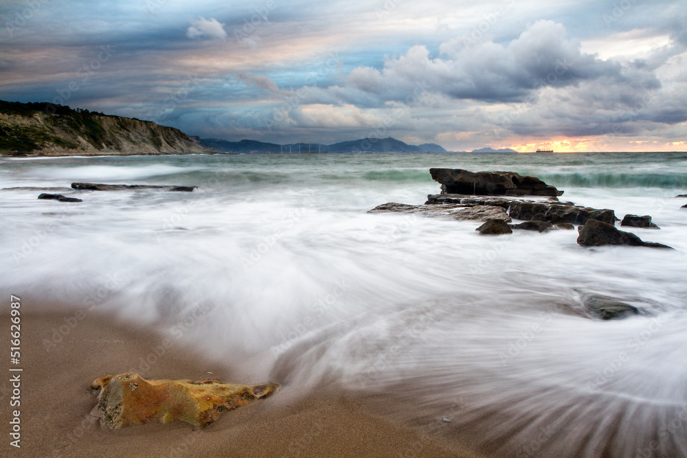 Fototapeta premium Sunset at Azkorri beach in the coast of Biscay, Basque Country, north of Spain. 