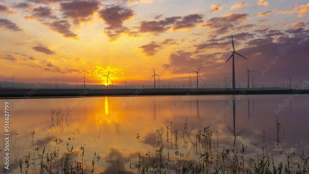 Windmills turbines with sunrise reflection Windmills turbines with sunrise reflection