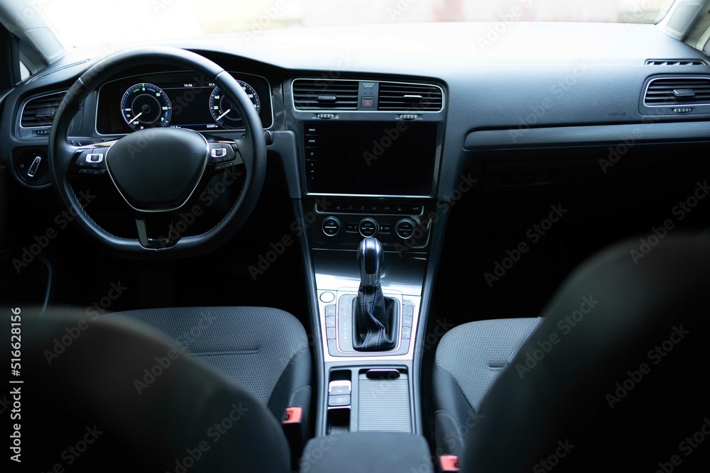 Electric car interior details adjustments. Inside car interior with front seats, driver and passenger, textile, windows, console, gear shift, electric buttons, digital speedometer