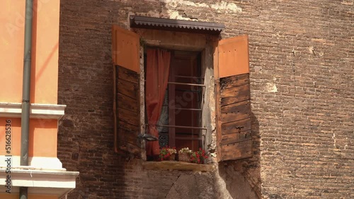 Close-up of an old, wooden, historic window on a historic brick wall.