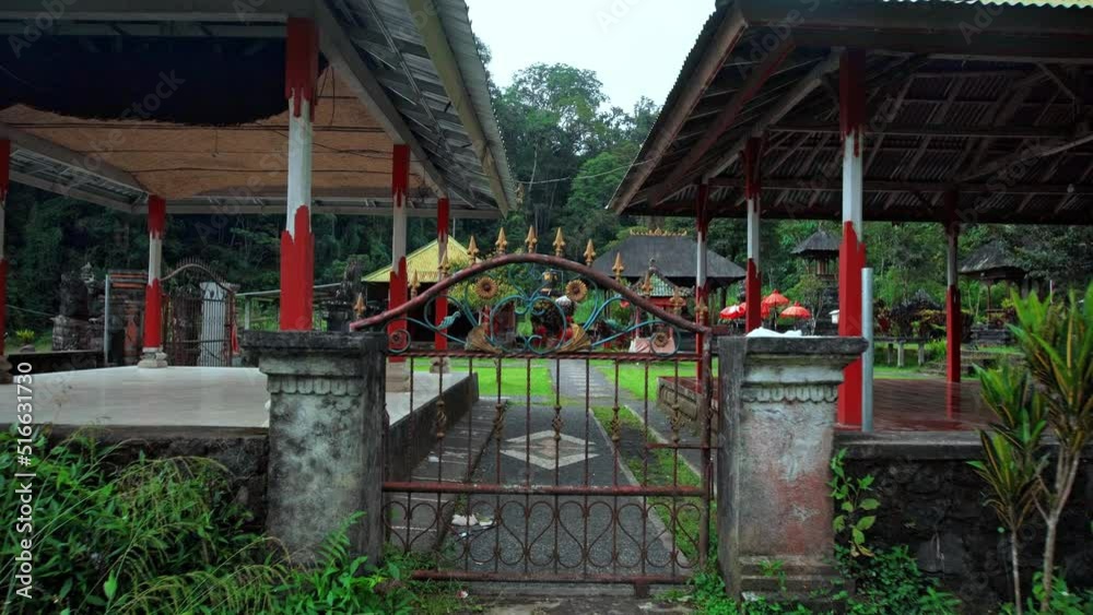 temple with roofs standing in a field near a forest with a fence temple with roofs standing in a field near a forest with a fence