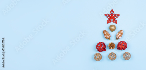 Christmas composition. Christmas balls of red and gold color, golden cones, red decorations on a light blue background. Christmas, winter, new year concept. Flat lay, top view, copy space