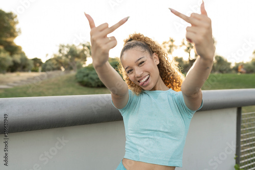 Принти на полотні Hispanic young woman in sportswear showing the middle finger making fuck you bad expression, provocation and rude attitude
