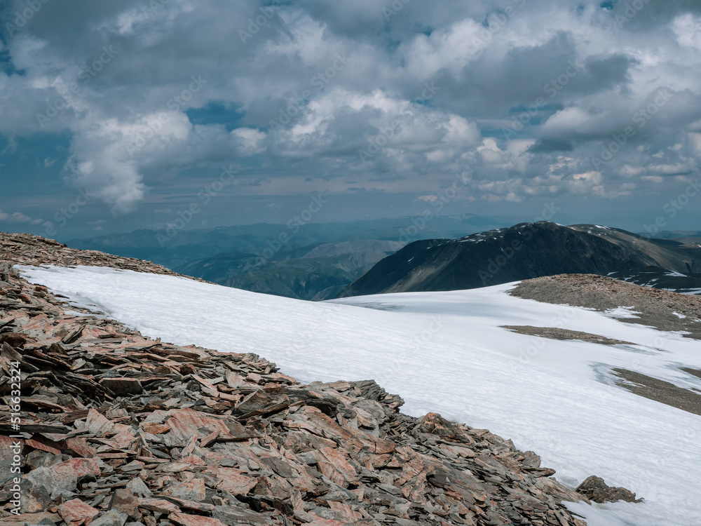 Low clouds, changeable weather in the mountains. Majestic mountains, harsh alpine nature background. Minimalist nature background of snowy mountainside. Low clouds, changeable weather in the mountains. Majestic mountains, harsh alpine nature background. Minimalist nature background of snowy mountainside.