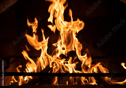 Fire flame in the fireplace. Tongues of flame on a black background. High quality photo