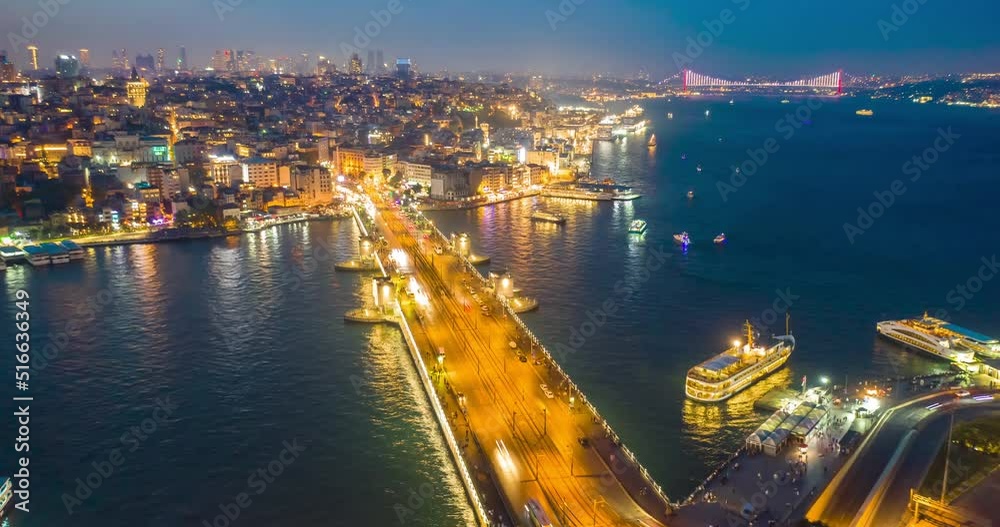 Drone Hyperlapse of Galata Bridge at sunset. Traffic of cars, boats and ships sailing, evening city lights. Istanbul, Turkey, aerial timelapse