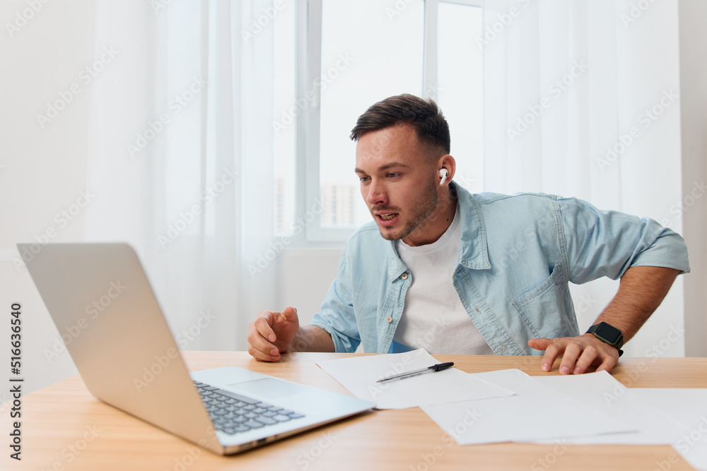 Crazy angry irritated handsome stylish young businessman scream at laptop hates computer crash operation problems in office. Copy space for ad. Remote Job, Technology And Career Profession Concept