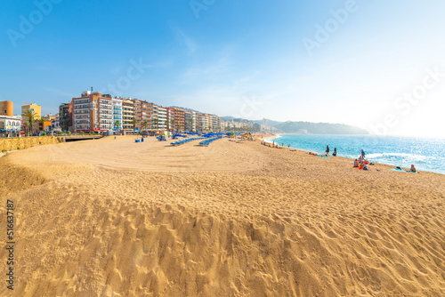 The wide sandy beach at the resort town of Lloret de Mar on the Costa Brava coast of the Mediterranean Sea in Southern Spain. photo