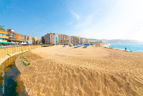 The wide sandy beach at the resort town of Lloret de Mar on the Costa Brava coast of the Mediterranean Sea in Southern Spain. photo