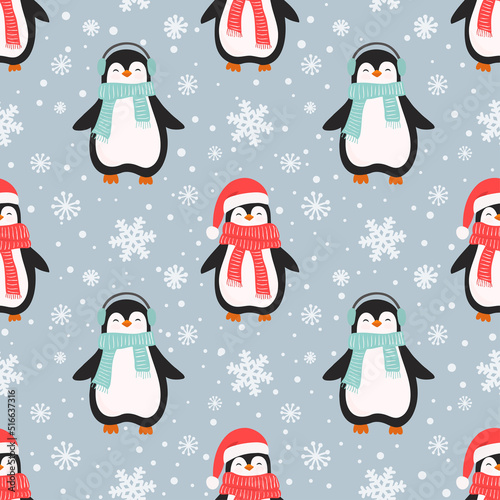 Christmas seamless pattern with cute cartoon penguins and and snowflakes.