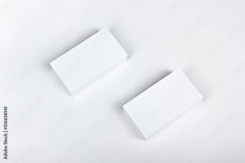 Mockup of business cards fan stack at white textured paper background. Top view. Mockup of business cards fan stack at white textured paper background. Top view.