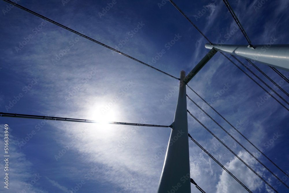 Modern cable-stayed bridge, sky and sun Modern cable-stayed bridge, sky and sun