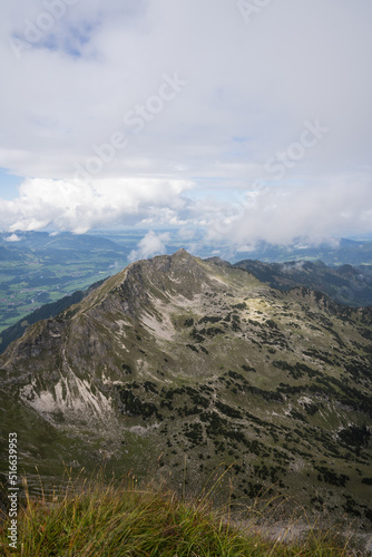 View to an Alpine valley with clouds