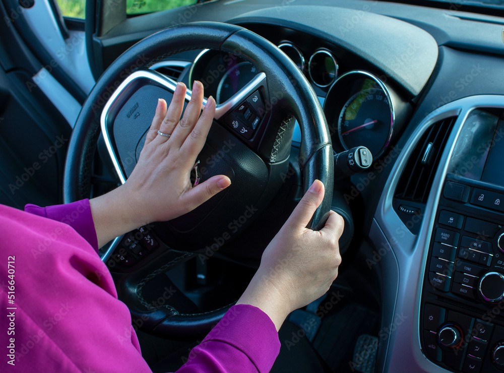 A hand honking the horn while driving. Anger in traffic. A hand honking the horn while driving. Anger in traffic.