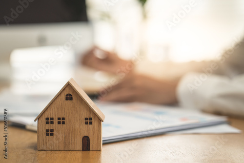 Hand of Business people calculating interest, taxes and profits to invest in real estate and home buying