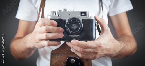 Man holding old retro camera.