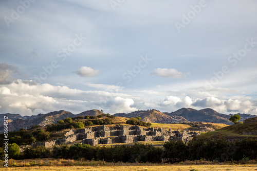 Distant view of the Inca ruins of saqsaywaman in Cusco on a day with clouds, Peru photo