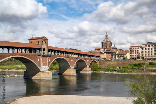 The Ponte Coperto (Covered Bridge) in Pavia, a brick arch bridge over the Ticino River, Lombardy, Italy
