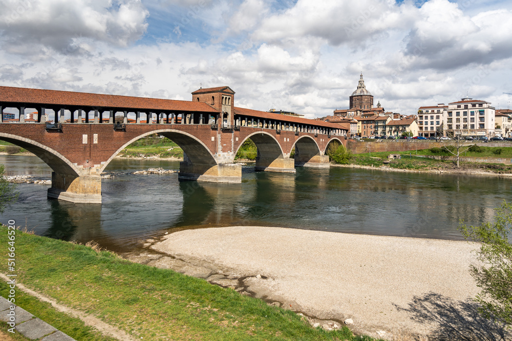 View of Ponte Coperto (Covered Bridge) crossing Ticino river, a famous landmark of Pavia, Lombardy, Italy