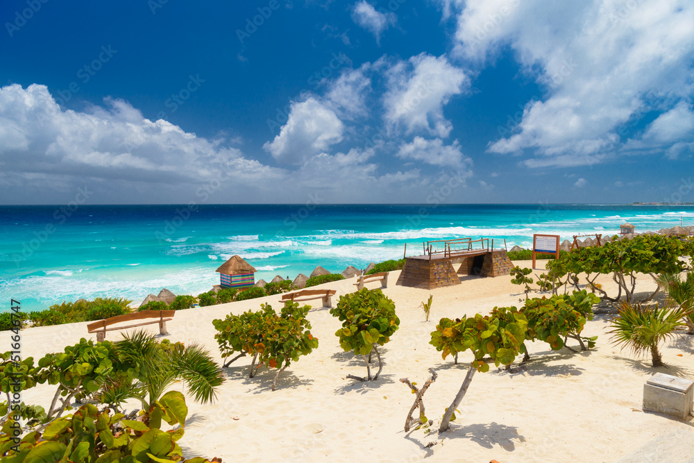 Sandy beach with azure water on a sunny day near Cancun, Mexico