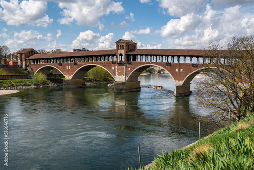 The Ponte Coperto (Covered Bridge) in Pavia, a brick arch bridge over the Ticino River, Lombardy, Italy