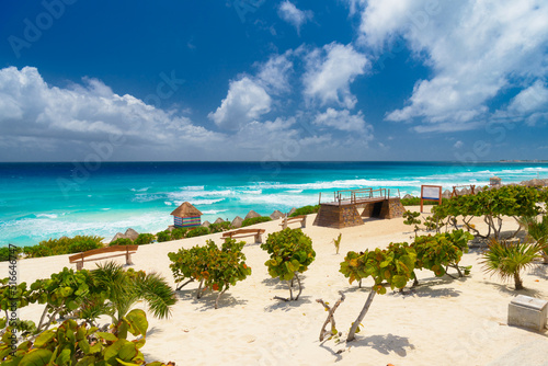 Sandy beach with azure water on a sunny day near Cancun, Mexico