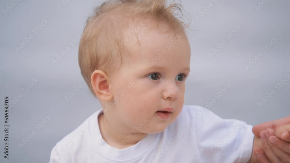 Beautiful smiling cute baby. Portrait of a happy child on a blue background. Funny happy child smiling at the camera. Beautiful smiling cute baby. Portrait of a happy child on a blue background. Funny happy child smiling at the camera.