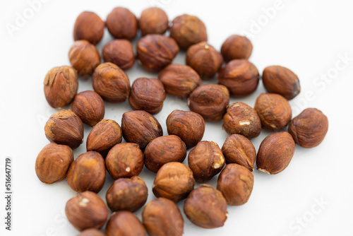 Hazelnuts without shell on a white background, isolated. Pile of hazelnut closeup.