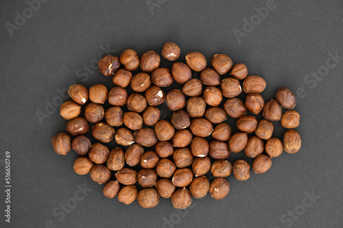 Hazelnuts on dark rustic wooden background
