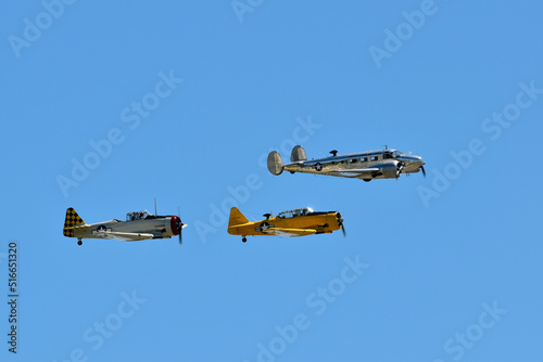 A Beechcraft Model 18, leads two AT6 Texans at an airshow. photo