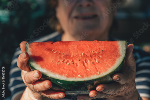 senior woman in hands with watermelon