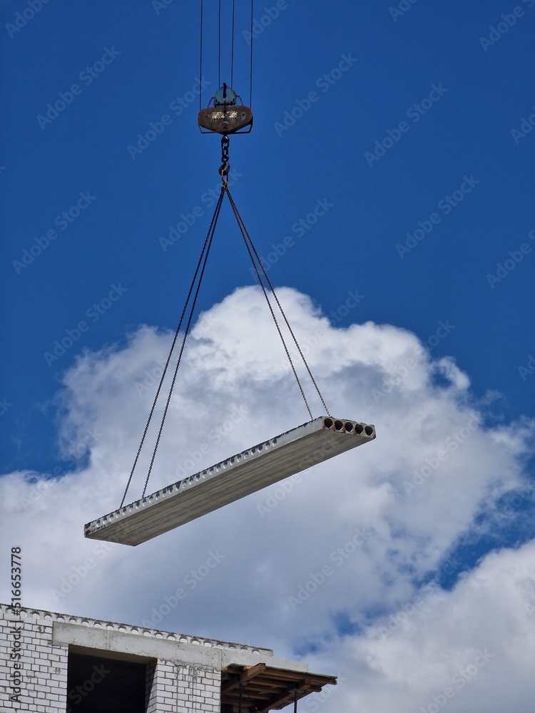 crane builds a house against the blue sky crane builds a house against the blue sky