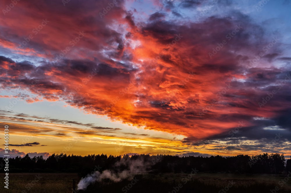 Dramatic evening red sunset sky with clouds